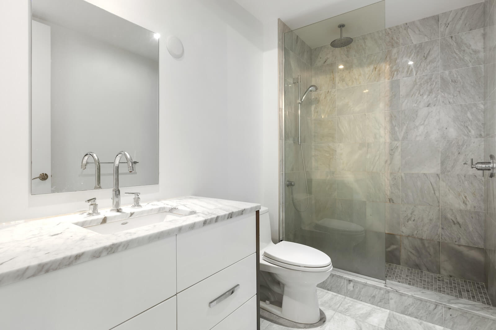Renovated bathroom - new shower head and faucets, new wall and floor tiles, new toilet, new mirror, new marble countertop, new bathroom cabinet